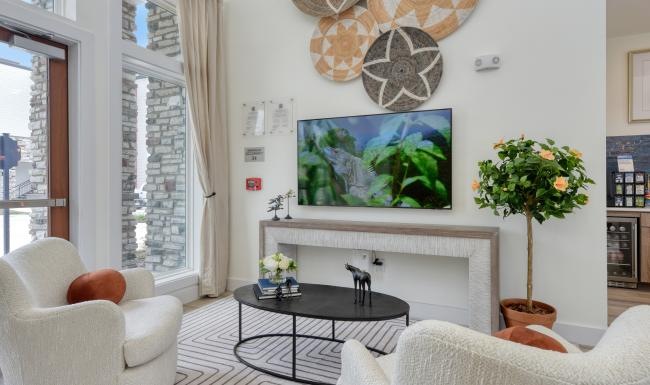 a clubroom with a tv, table and chairs