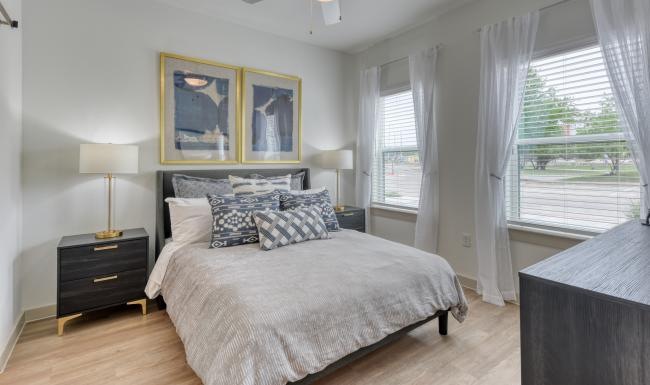 a bedroom with a bed and two nightstands