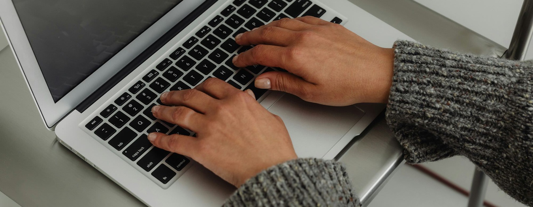 A person typing on a laptop.