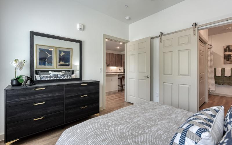 a bedroom with a bed and dresser